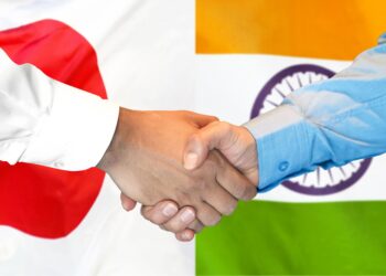 Japan India partnership handshake with national flags representing technology cooperation and investment collaboration