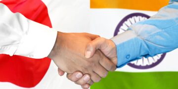 Japan India partnership handshake with national flags representing technology cooperation and investment collaboration
