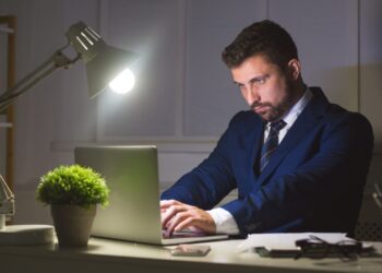 Indian professional building side hustle business on laptop while working from home