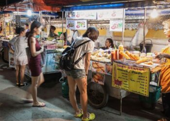 Busy street food stalls in Chandni Chowk Old Delhi one of India's most famous destinations for food travellers
