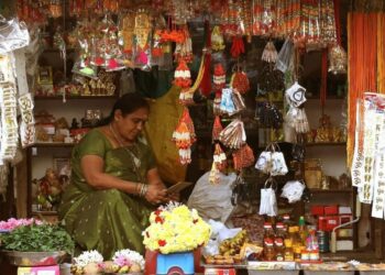 Busy festive market in India during Eid al-Adha with shoppers purchasing clothing and food for the celebration