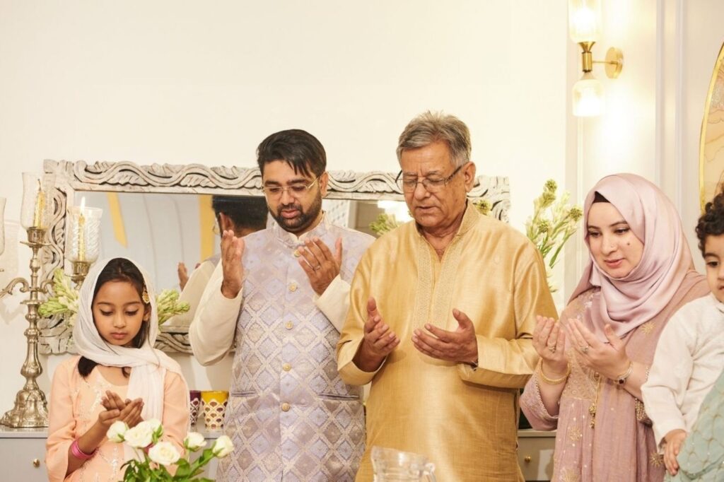 Indian family gathering for a festive meal during Eid al-Adha reflecting community and consumer traditions