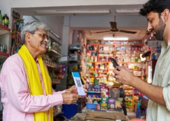 Indian street vendor accepting UPI digital payment via QR code scan representing India's fintech revolution in 2026