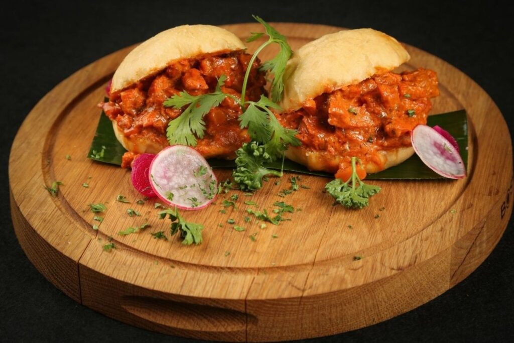 Street vendor serving vada pav in Mumbai one of India's most iconic and beloved street food dishes for travellers