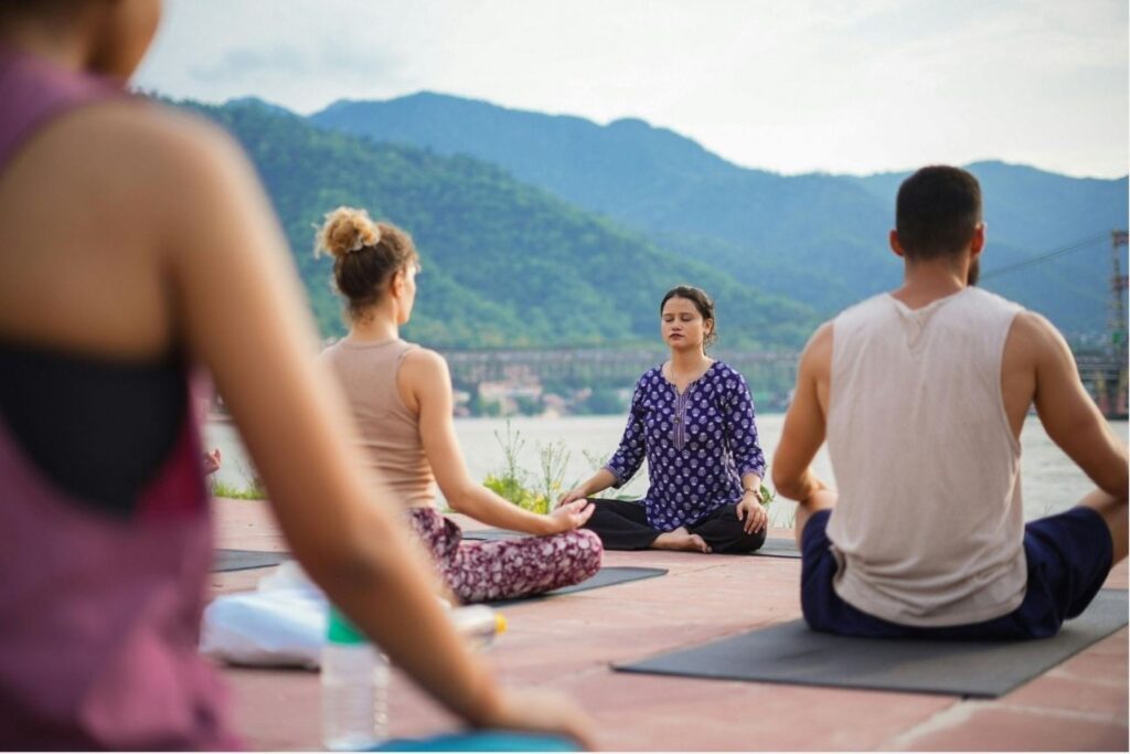 Wellness traveller in morning yoga session at Himalayan Ayurveda retreat in Rishikesh India