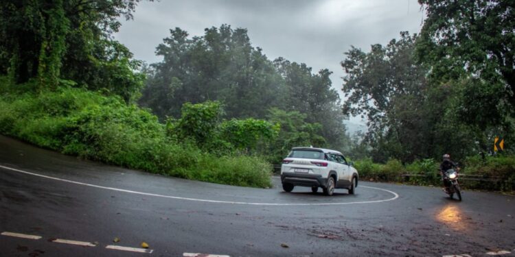 Screenshot_2026-06-30_121730 - INDIAwebzine A woman driving during monsoon road trips in India, with misty green hills visible through the windshield