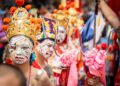 A monk in an ornate mask performs during Hemis Festival in the monastery courtyard in Ladakh