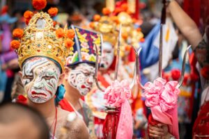 A monk in an ornate mask performs during Hemis Festival in the monastery courtyard in Ladakh