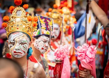 A monk in an ornate mask performs during Hemis Festival in the monastery courtyard in Ladakh