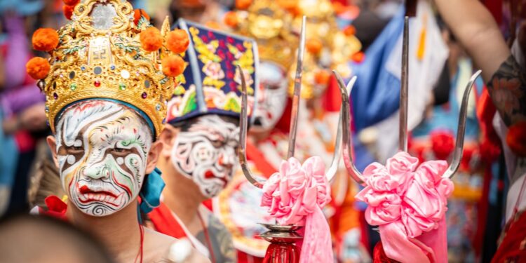 A monk in an ornate mask performs during Hemis Festival in the monastery courtyard in Ladakh