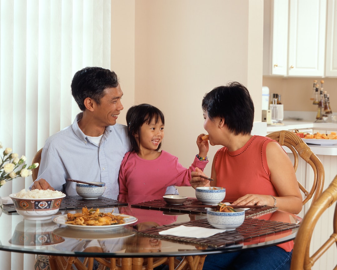 An Indian family sits together at a breakfast table filled with millet dishes, representing a shared gluten-free breakfast