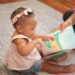 A mother and child reading an Indian mythology book together on the floor at home