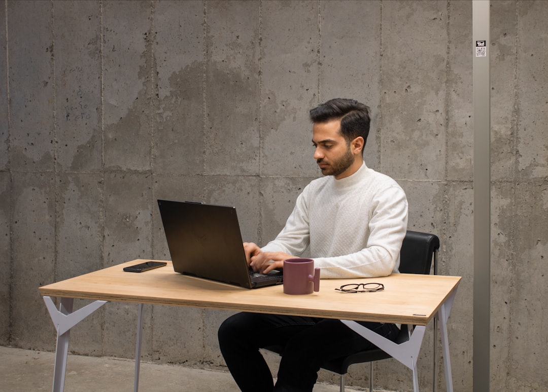 A focused Indian founder reviews analytics on a laptop, tracking sales data for a D2C brand in India