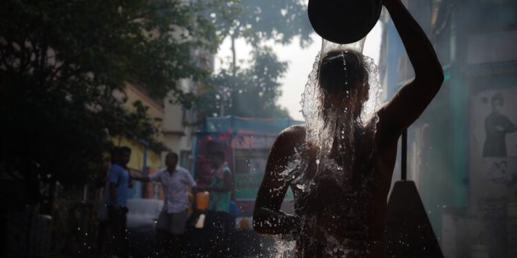 A young Indian woman touching her frizzy monsoon hair after stepping out in the rain on a humid June morning