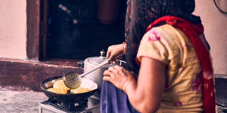A woman prepares a traditional ragi dosa, one of the most popular naturally gluten-free breakfast dishes.