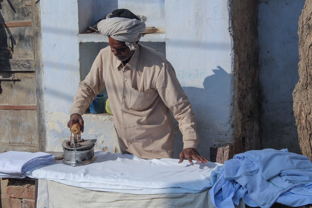A craftsman stirs an indigo vat as part of the natural dyes process in a rural Indian textile workshop