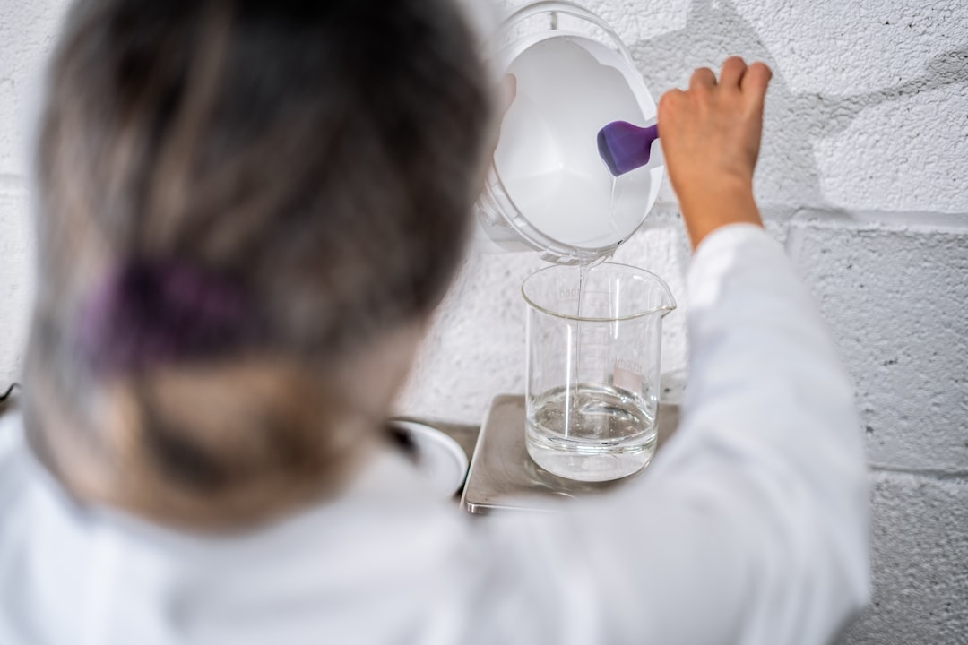 A young Indian child watching the fizzing reaction during science experiments done at home with kitchen ingredients