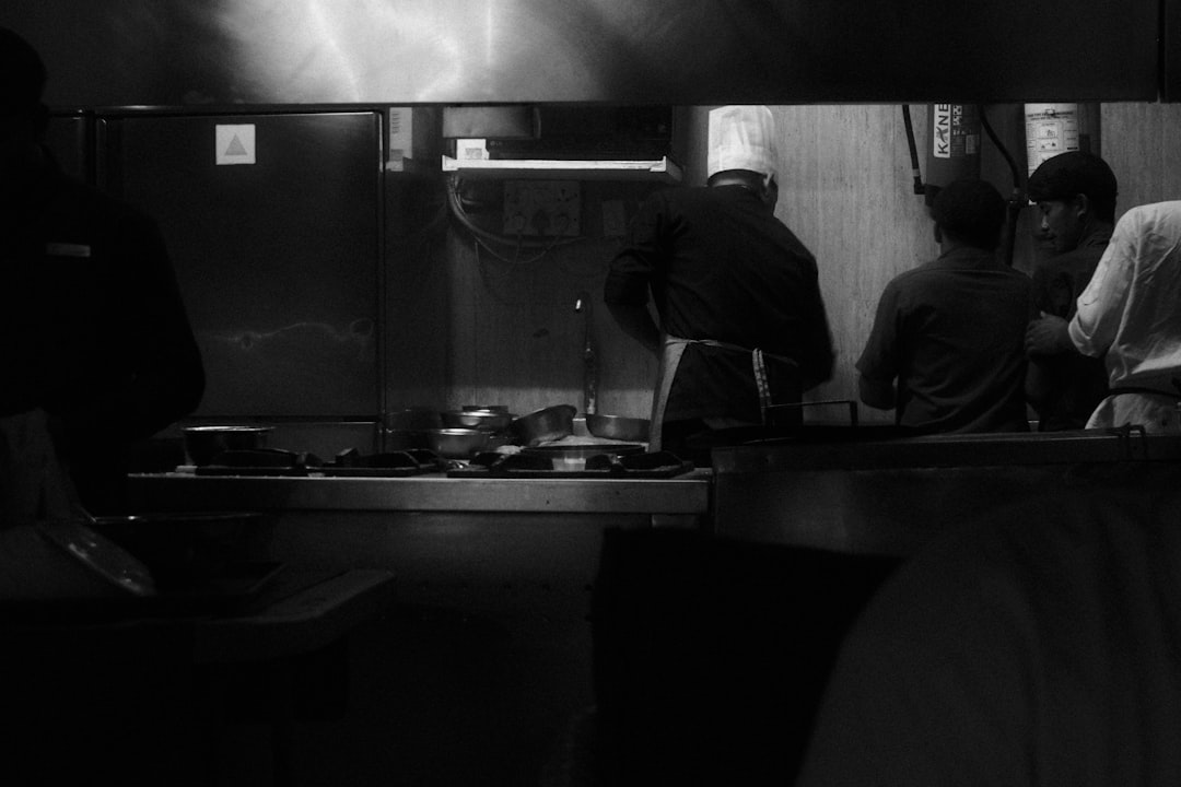A chef prepares dishes inside a compact cloud kitchen, ready to fulfill food delivery orders as monsoon season drives demand