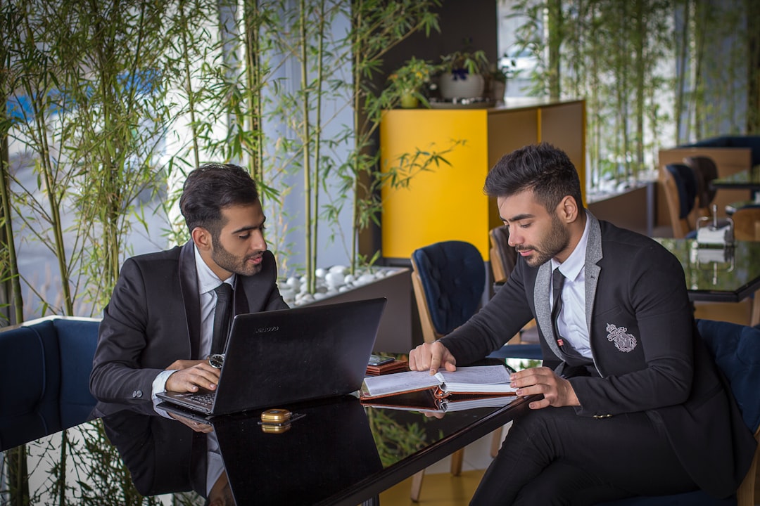 A small team of Indian entrepreneurs discussing sections of an annual report to guide their equity investment decisions