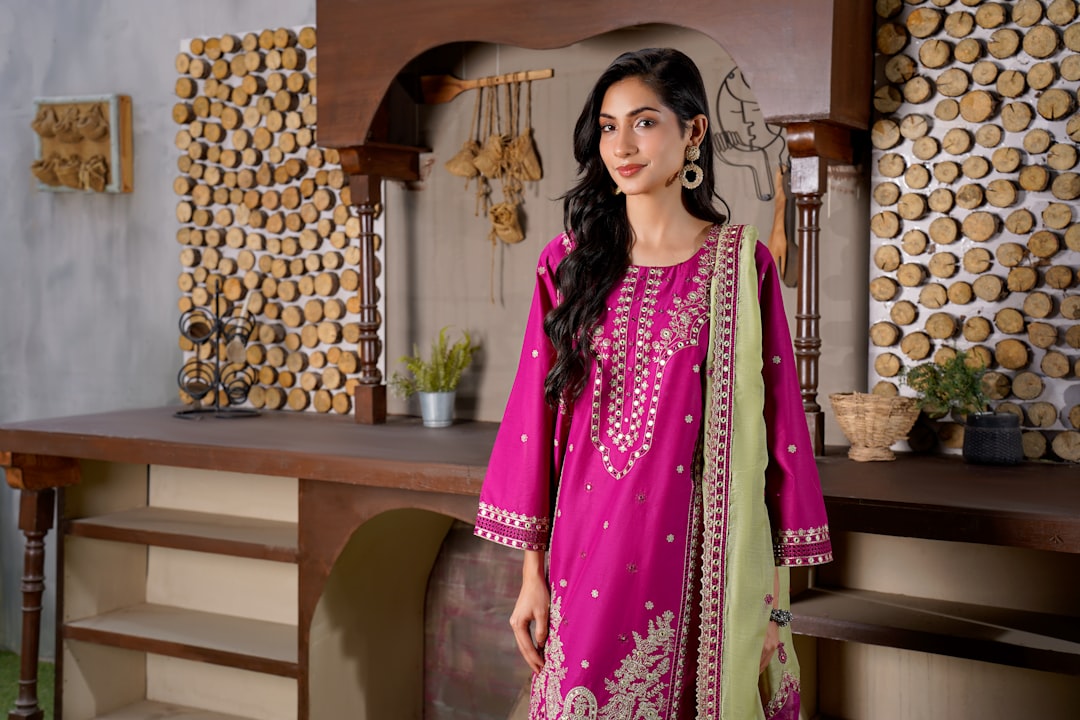 A young Indian fashion designer wearing outfit made with natural dyes in an urban studio setting