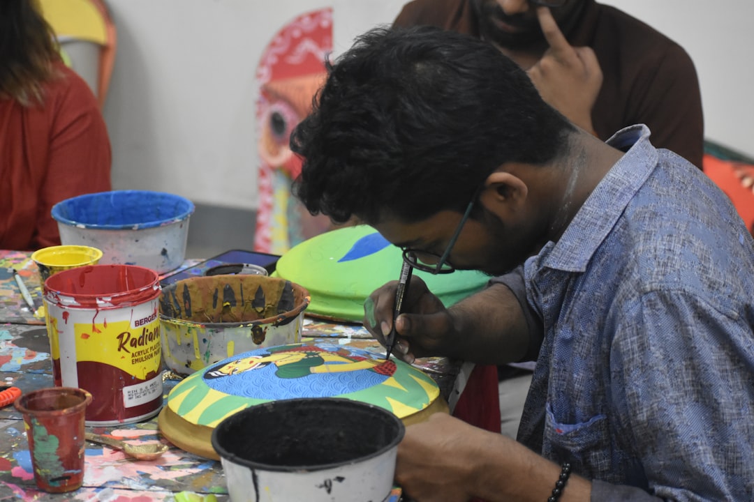 A group of students learning Warli art during a hands-on community workshop in India