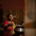 A grandmother teaches her granddaughter a traditional recipe, showing how the Indian diaspora passes culinary heritage.