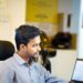 indian-investor-in-office-unsplash - INDIAwebzine A young Indian woman checks the IPO market on her smartphone during monsoon season in India