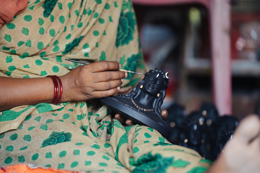 An Indian maker packaging handmade products after calculating handmade pricing for online sale