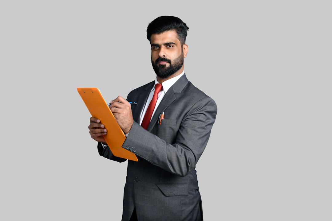 An Indian professional consulting documents about sovereign gold bonds at a bank branch counter