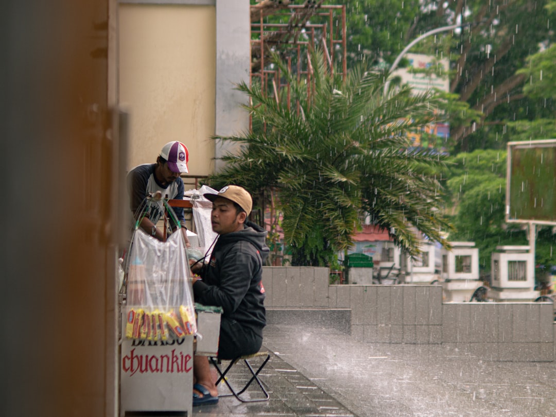 A street food vendor cooking fresh hot food at a stall while rain falls, highlighting the importance of gut health
