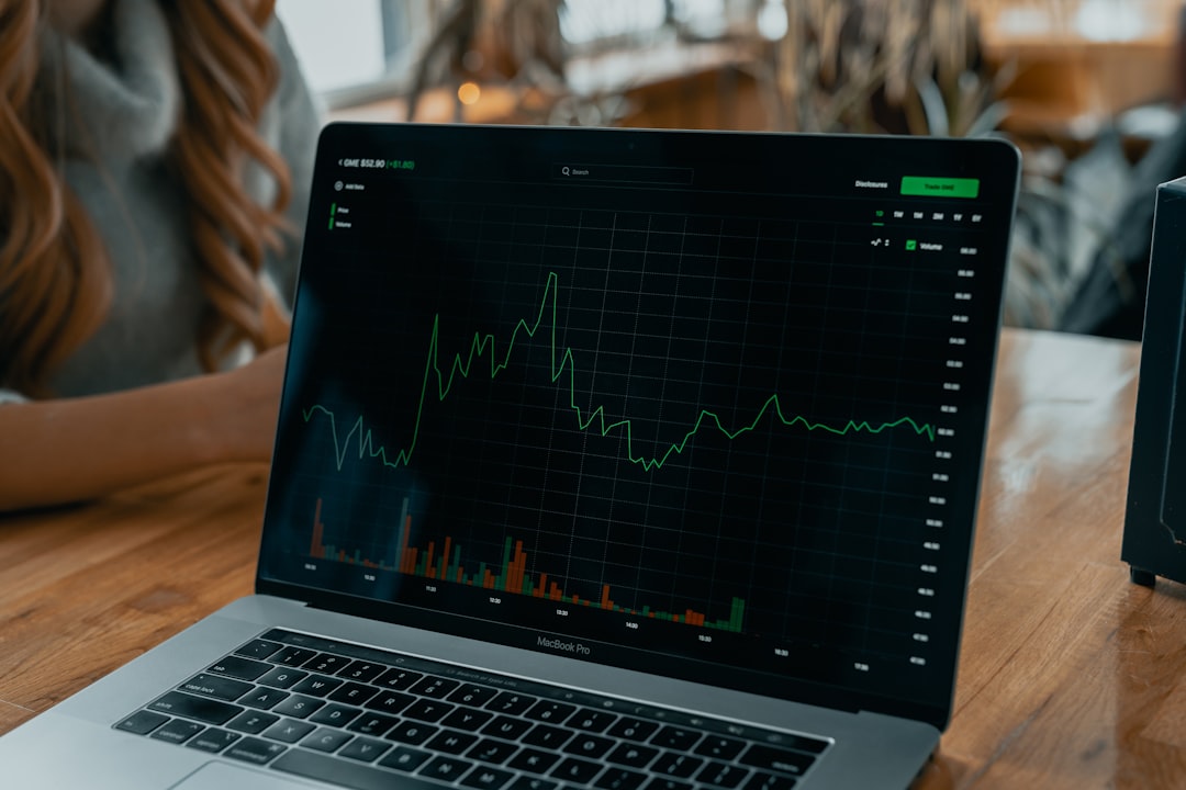 A young Indian investor analysing an annual report on a laptop screen to evaluate equity options