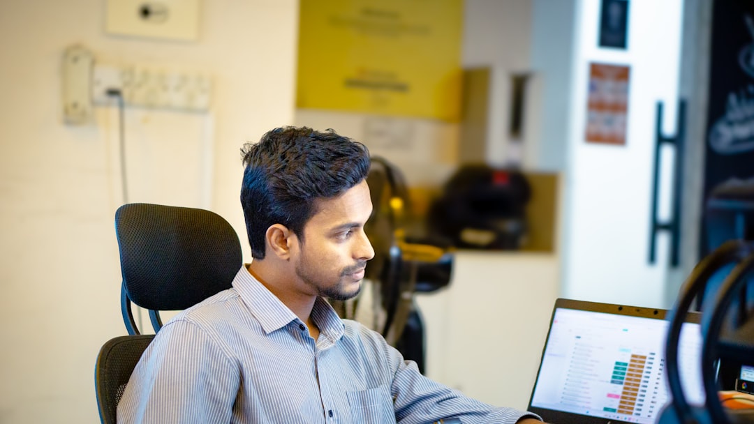 A young Indian man works at his startup desk, embodying the energy of India's demographic dividend in the modern economy.