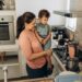 A mother and child performing science experiments at home using turmeric and bowls on a kitchen counter in India