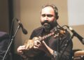 A sitar player records for his independent digital label in a home studio in India