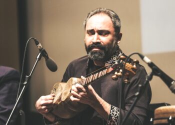 A sitar player records for his independent digital label in a home studio in India