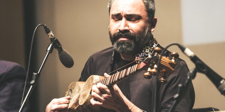 A sitar player records for his independent digital label in a home studio in India