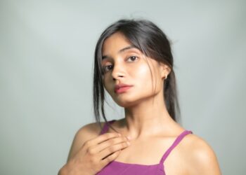 Young Indian woman applying a lightweight gel moisturizer as part of her monsoon skincare routine at home