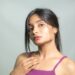 Young Indian woman applying a lightweight gel moisturizer as part of her monsoon skincare routine at home