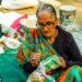 indian-woman-artisan-pricing-products-unsplash - INDIAwebzine An Indian woman artisan reviewing handmade pricing beside her craft products