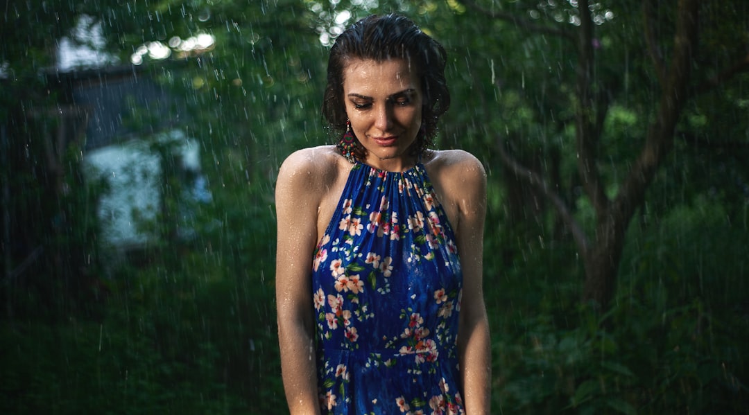 Indian woman applying SPF sunscreen outdoors during the rainy season as part of her monsoon skincare routine