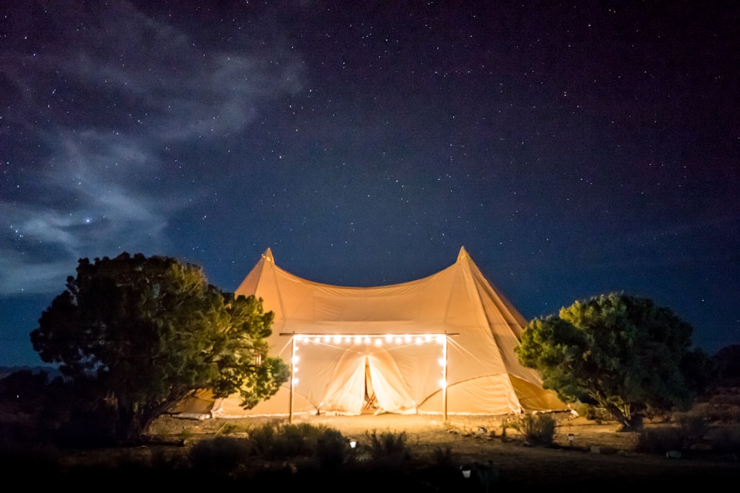 A guest relaxes on the veranda of a luxury tent at one of India's top wildlife lodges at sunrise