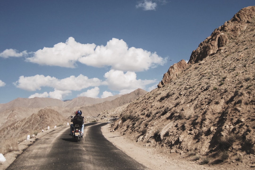 Motorcycle riders traveling through the Himalayan highway during a Kargil Vijay Diwas commemorative expedition in Ladakh