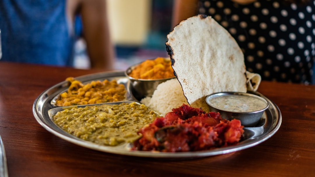 a bowl of hot monsoon dal over steamed rice in a South Indian home setting.