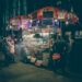 street-vendor-selling-unsplash - INDIAwebzine A smiling street vendor fries golden pakoras at a busy stall, capturing the joy of monsoon street food in Delhi