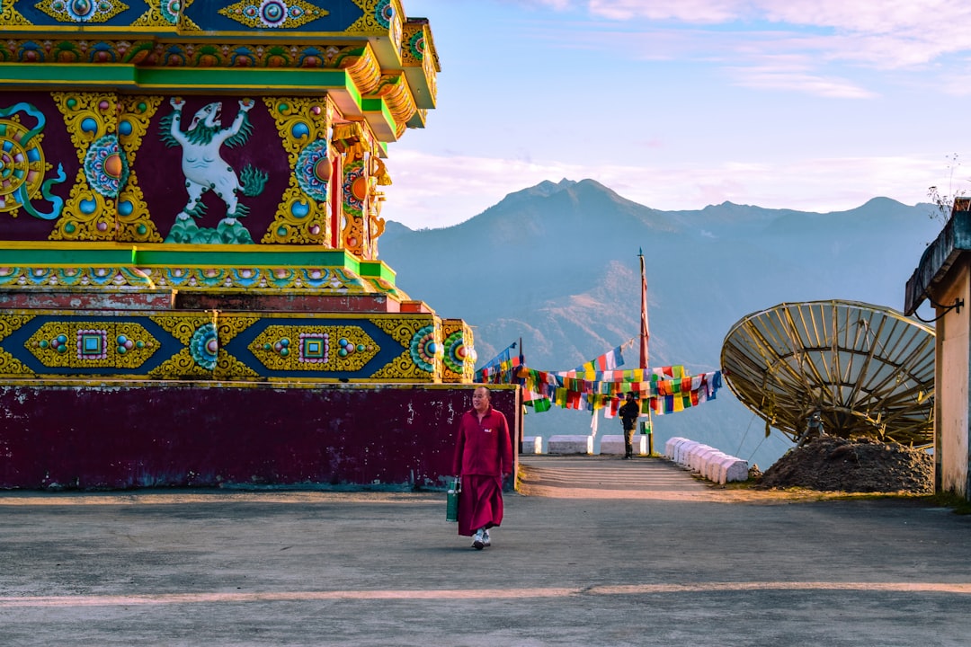 A visitor stands at the entrance of Tawang Monastery, one of the sites on the Northeast Buddhist circuits of India