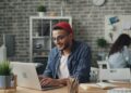 A young entrepreneur works in a co-working space, representing the rise of startup funding in India's tier-2 cities