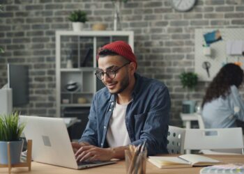 A young entrepreneur works in a co-working space, representing the rise of startup funding in India's tier-2 cities