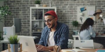 A young entrepreneur works in a co-working space, representing the rise of startup funding in India's tier-2 cities