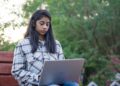young-indian-woman-studying-laptop-unsplash - INDIAwebzine A young Indian woman studies on her laptop, representing India's demographic dividend generation preparing for the future.