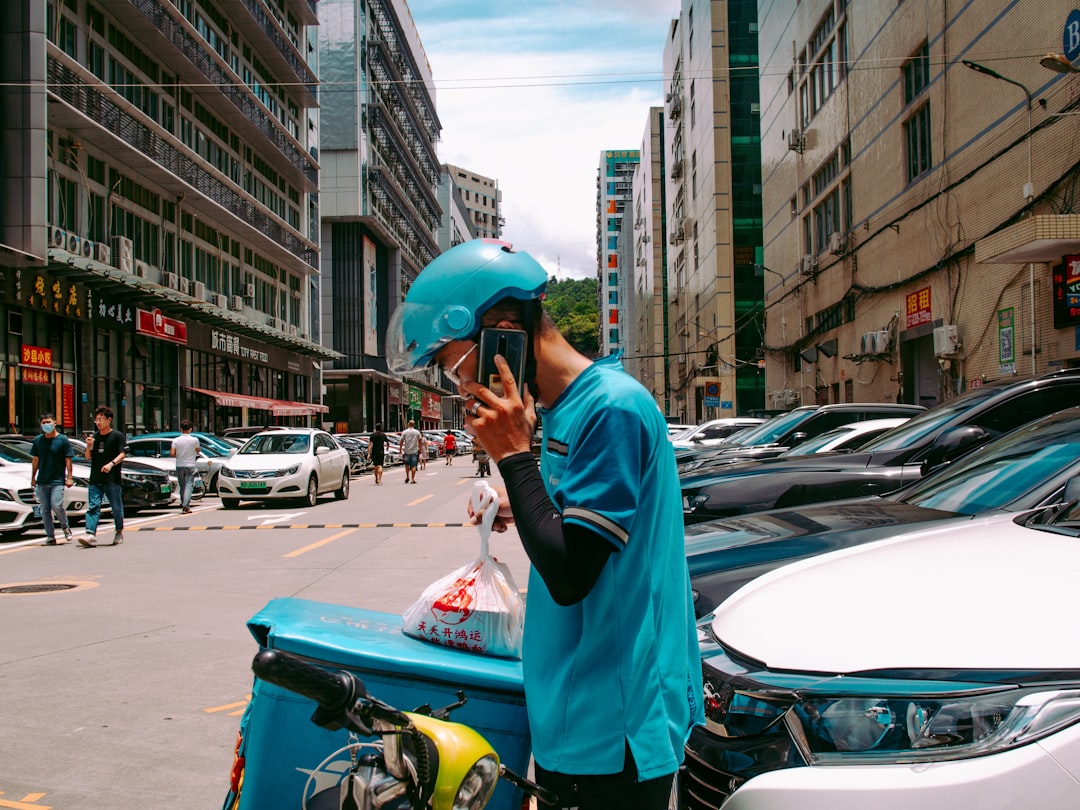 A young Indian man browses a food delivery platform on his smartphone, reflecting the demand during monsoon season